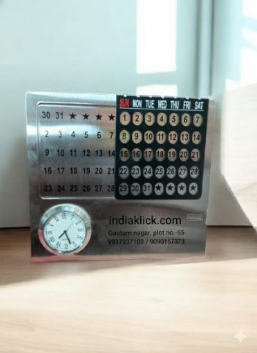 Picture of SILVER SS MONTH TABLE CALENDER WITH A WATCH ON IT.